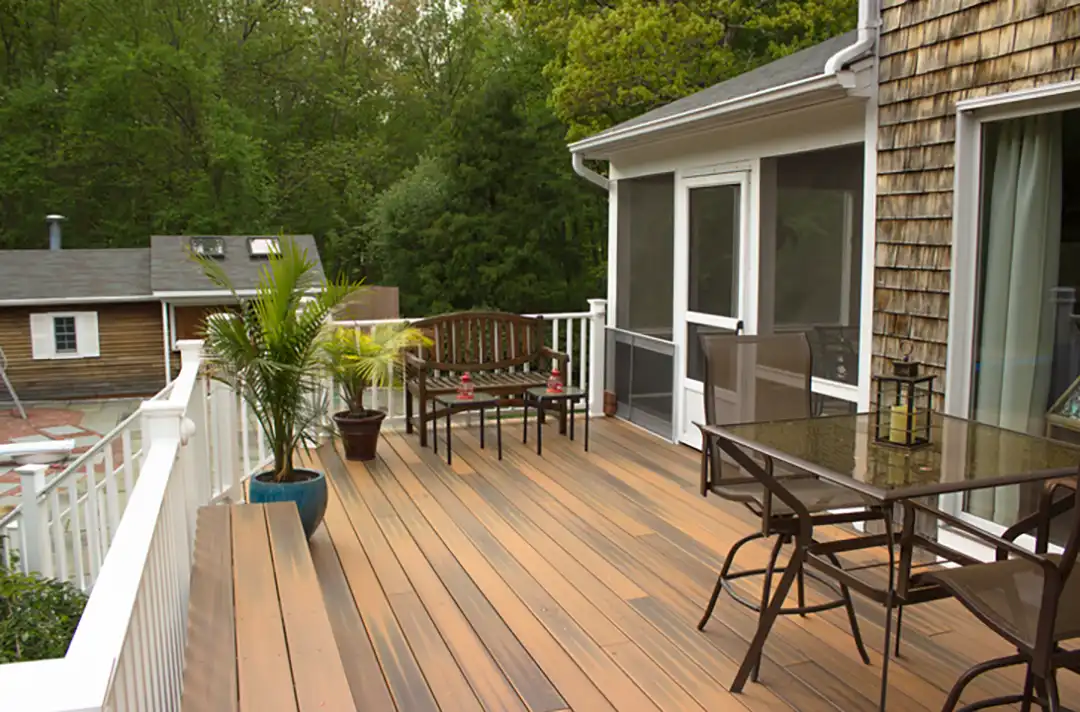 Composite decking offers several benefits, making it a popular choice for homeowners and business owners alike. Key advantages include: Durability Against Weathering: Composite decking is specifically designed to resist weather-related damage. Unlike natural wood, composite materials do not succumb to rot or mold after prolonged exposure to various weather conditions. This durability is particularly beneficial in climates where decks are subject to rain, snow, or high humidity. Low Maintenance Requirements: Maintaining a composite deck is relatively straightforward. While it's important to clean the surfaces regularly to prevent mold growth, composite decking generally requires less upkeep compared to natural wood. This low-maintenance aspect is a significant draw for those who prefer spending more time enjoying their outdoor space rather than maintaining it. Resistance to Color Fading: Manufacturers design composite materials to resist ultraviolet light from the sun, which helps in reducing the likelihood of premature color fading. This feature ensures that the aesthetic appeal of the deck remains consistent over time. Variety in Design: Composite decking is available in a wide range of colors and textures, allowing for customization according to personal aesthetic preferences and the architectural style of the home. This variety enables homeowners to choose decking that complements their outdoor space and overall property design. Mold-Resistant: As mold resistance is a significant concern for outdoor decking, composite materials are often the preferred choice due to their ability to prevent large concentrations of spore buildup. This feature is especially important in humid climates where mold growth can be a persistent issue. Long-term Cost-Effectiveness: Although the upfront cost of composite decking might be higher compared to natural wood, its durability, low maintenance, and longevity make it a cost-effective solution in the long run​​​​. When considering the construction or renovation of a deck, homeowners often find themselves weighing the pros and cons of traditional wood decks against the increasingly popular composite decks. Each material offers unique benefits and drawbacks that are important to understand before making a decision. Composite Decking Products vs Natural Wood photo - Timeless Custom Decks