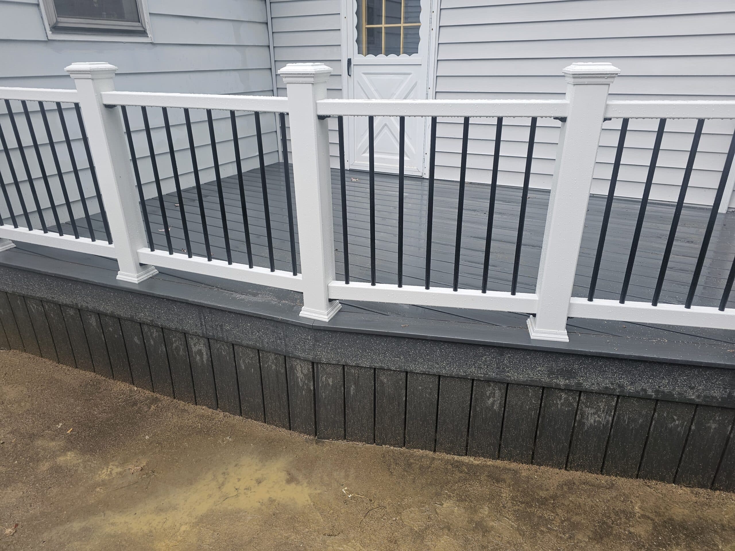 Trex deck railing with composite deck railing posts and black metal balusters