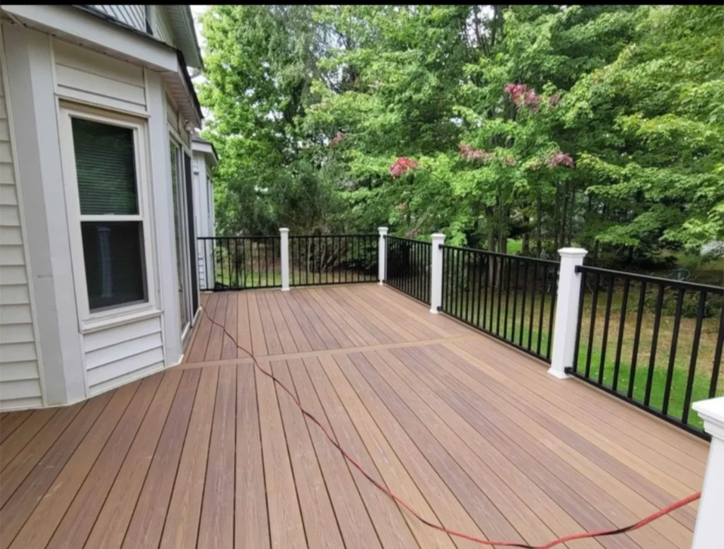 Deck with a Black Railing Surrounded by Trees