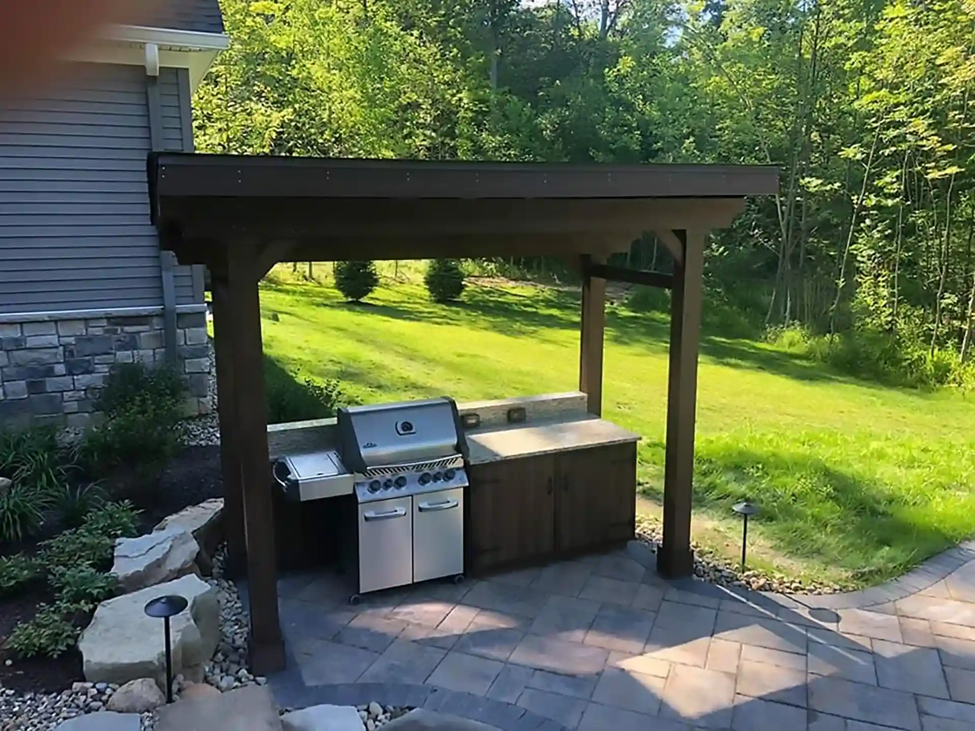 photo of an outdoor kitchen on a patio with a patio cover, which are outdoor living features - Outdoor Kitchens Contractors near me in Ohio