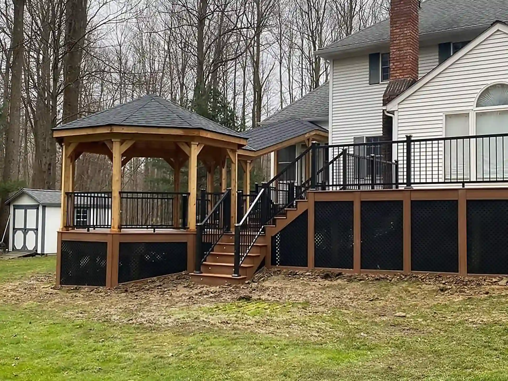 multi-level deck with gazebo and covered walkway to the house