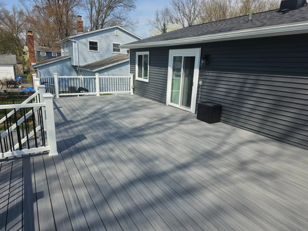 Deck Featuring a White Railing with a View of Trees and the Sky